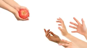 hands grabbing for apple
