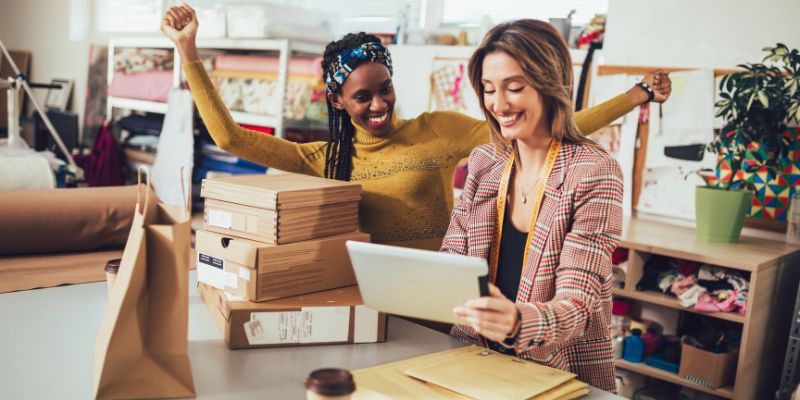 women happy looking at growing sales in website orders